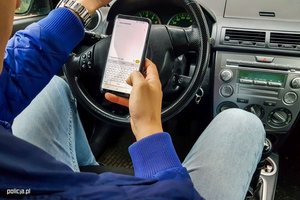 kierowca trzyma telefon w ręce