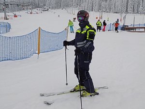 Policjant w stroju narciarskim na stoku